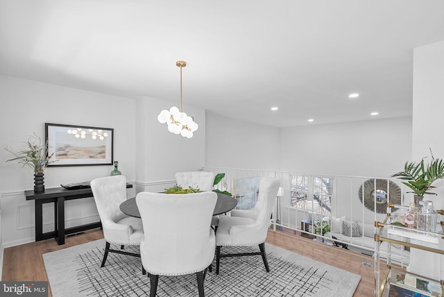 dining room with dark hardwood / wood-style flooring and a notable chandelier