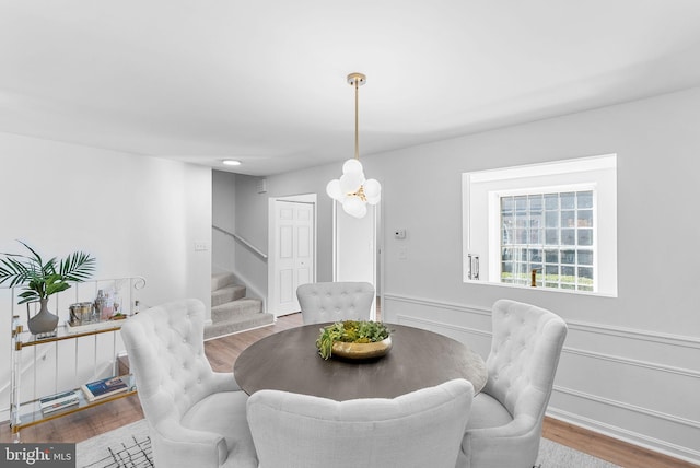 dining space featuring a chandelier and light hardwood / wood-style flooring