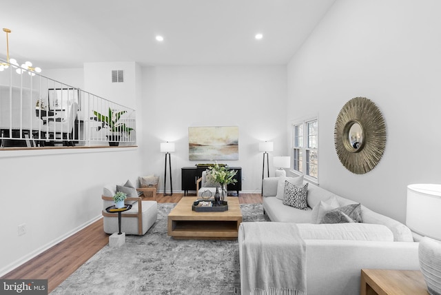 living room with hardwood / wood-style floors and a notable chandelier