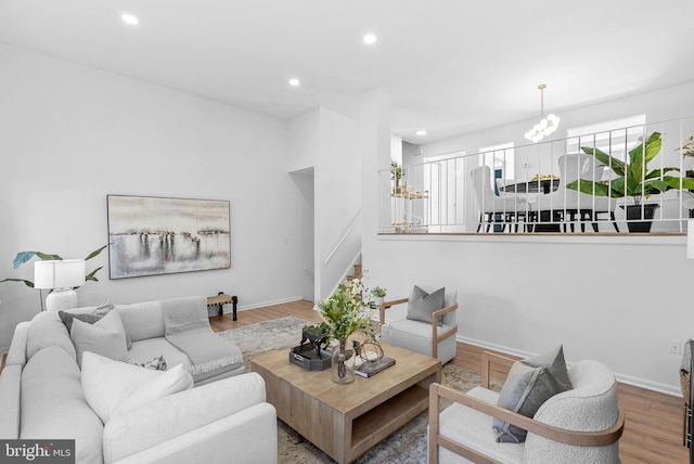 living room featuring hardwood / wood-style flooring and a notable chandelier