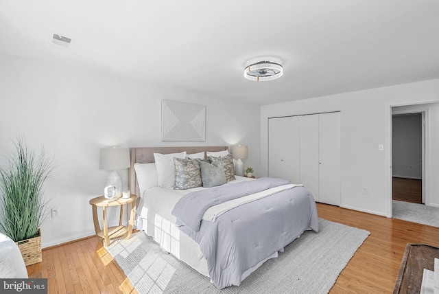 bedroom with hardwood / wood-style floors and a closet