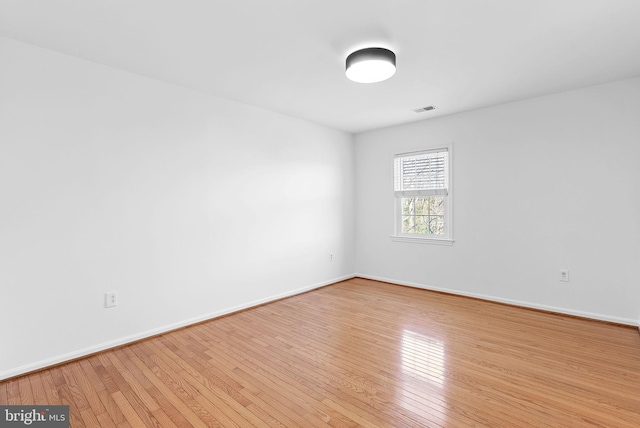 empty room with light hardwood / wood-style flooring