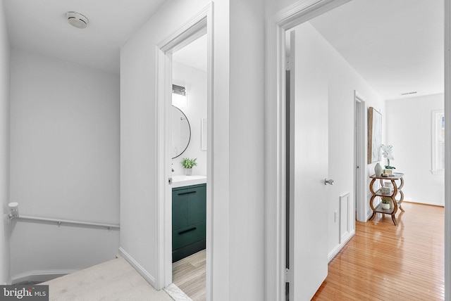 corridor with light hardwood / wood-style flooring