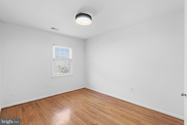 unfurnished room with light wood-type flooring