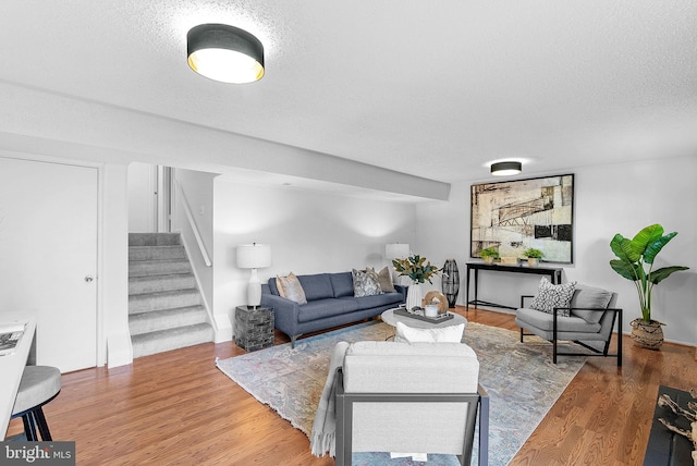 living room with hardwood / wood-style floors and a textured ceiling