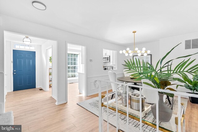 dining area featuring a chandelier and light hardwood / wood-style flooring