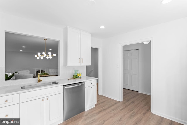 kitchen with sink, white cabinetry, decorative light fixtures, dishwasher, and light hardwood / wood-style floors