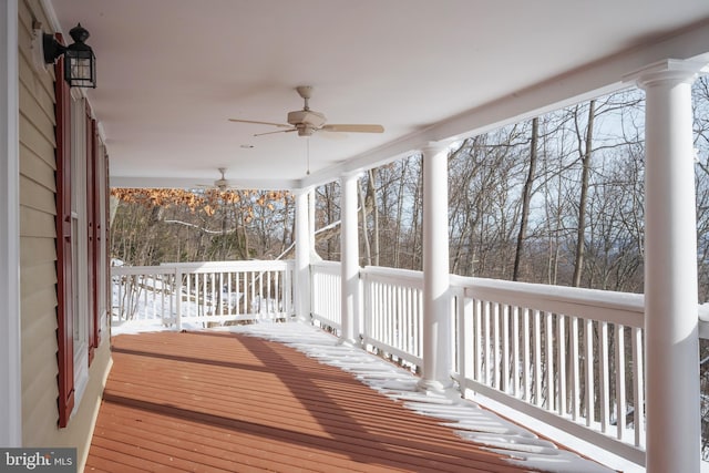 snow covered deck with a porch and ceiling fan