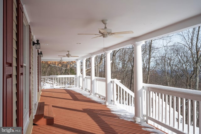 snow covered deck featuring a porch and ceiling fan