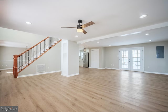 unfurnished living room with french doors, ceiling fan, light hardwood / wood-style flooring, beamed ceiling, and electric panel