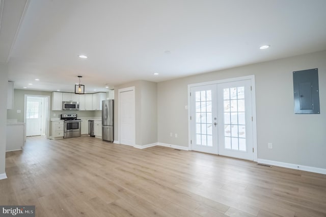 unfurnished living room with light wood-type flooring, electric panel, and french doors