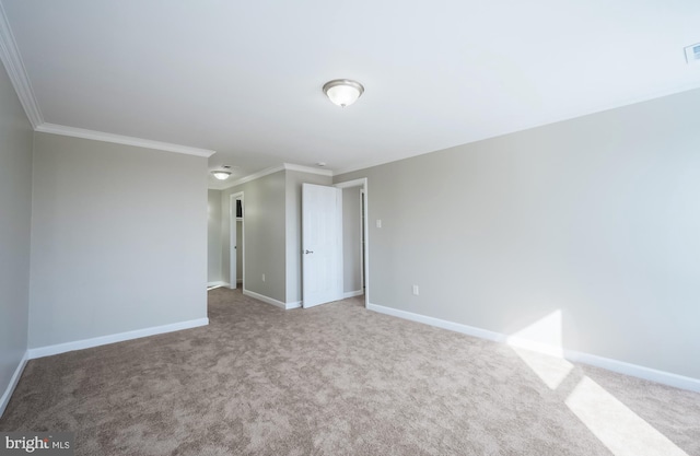 unfurnished room with carpet flooring and crown molding