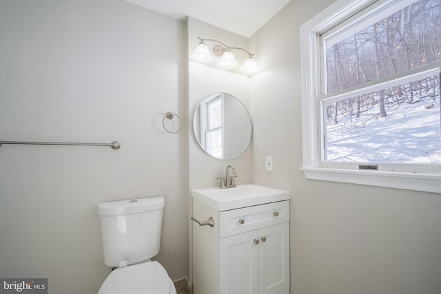 bathroom featuring vanity, toilet, and plenty of natural light