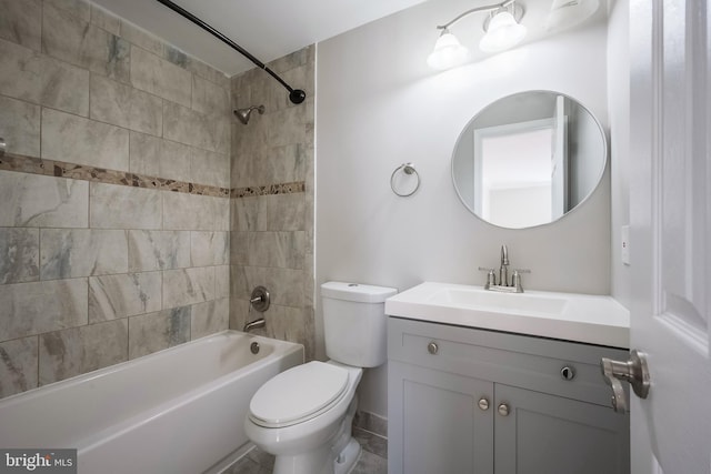 full bathroom featuring toilet, vanity, and tiled shower / bath