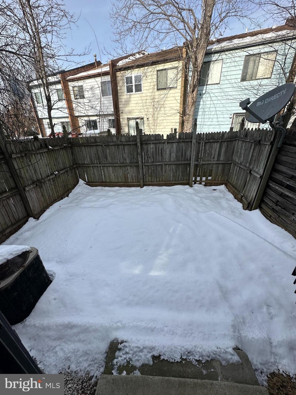 yard covered in snow with central AC