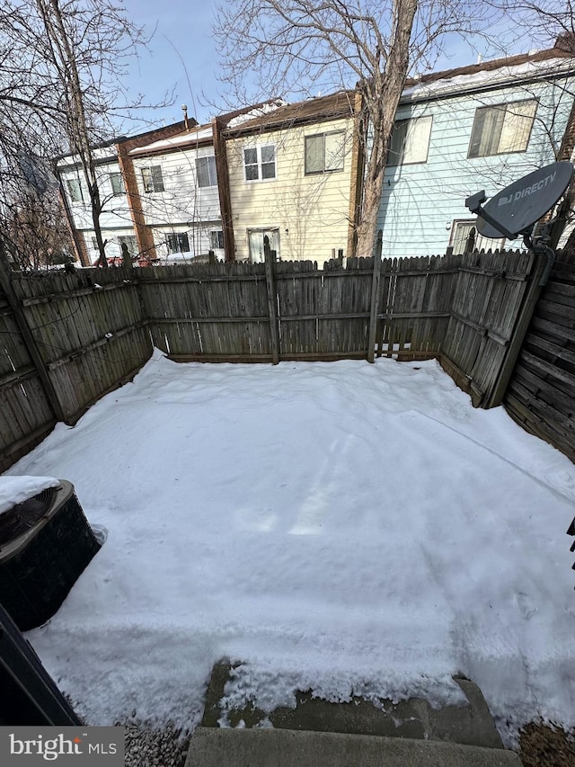 yard covered in snow with central AC