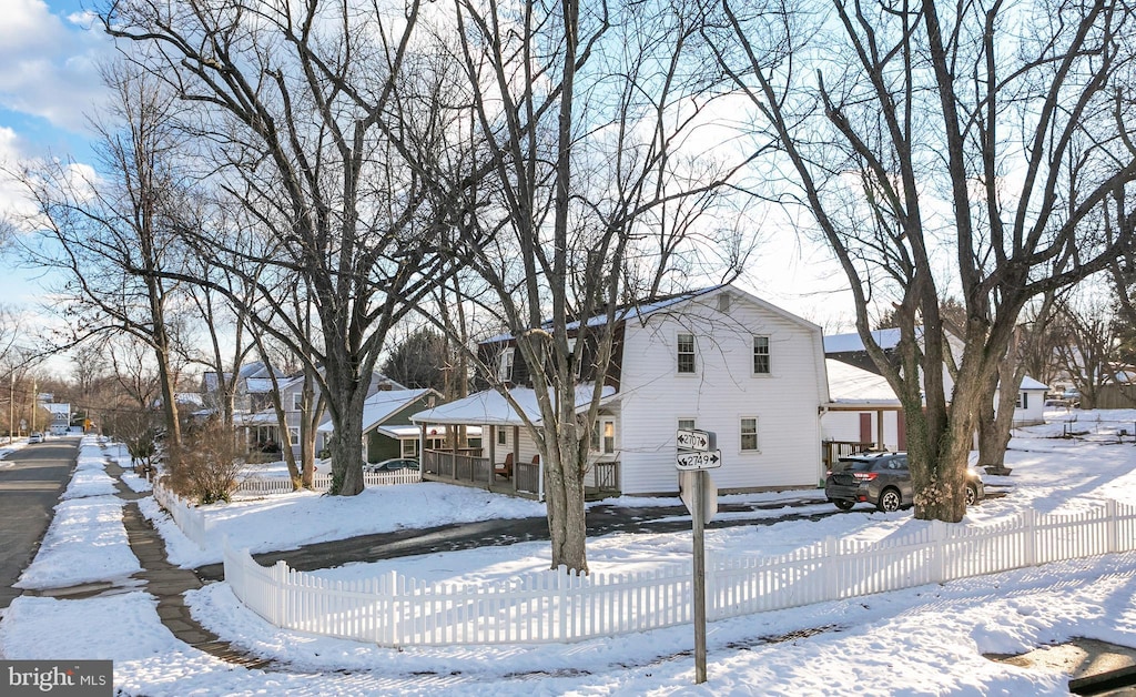 view of snow covered exterior with a porch