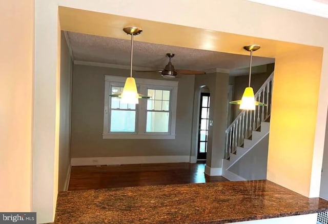 entrance foyer with ceiling fan and ornamental molding