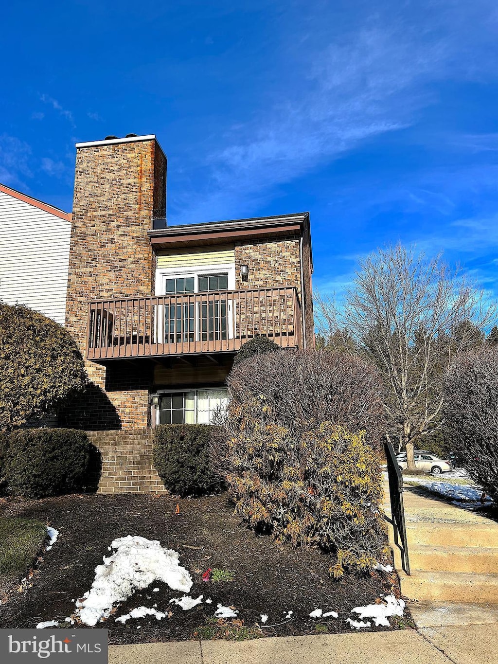 view of side of home featuring a balcony