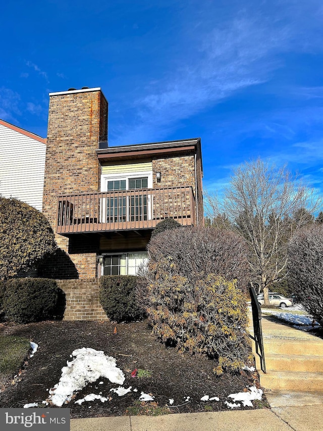 view of side of home featuring a balcony