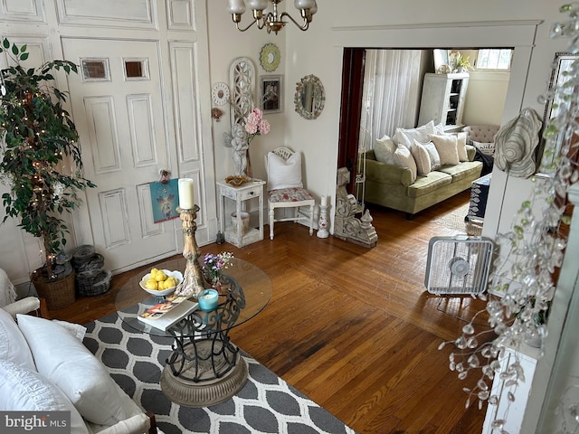 living room with a notable chandelier and wood-type flooring