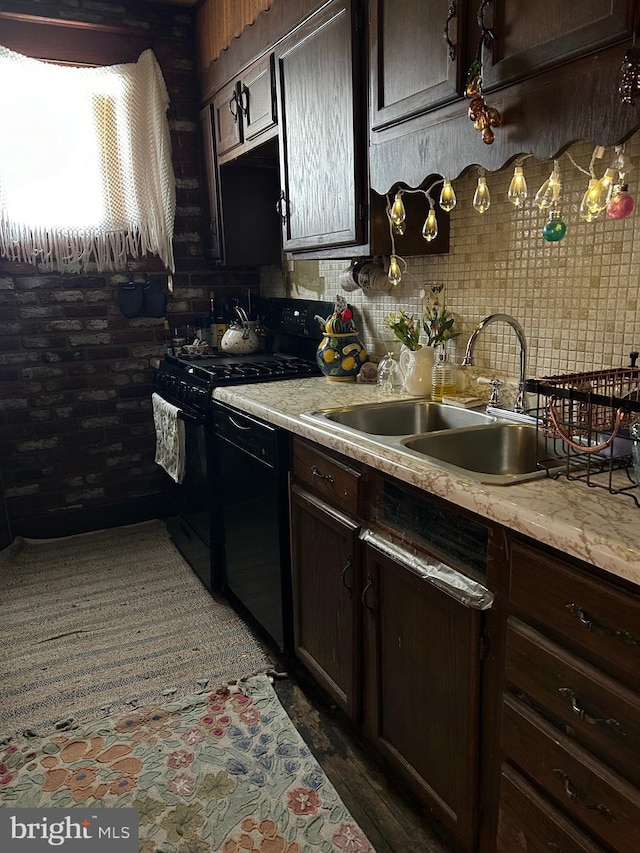 kitchen featuring black appliances, dark brown cabinets, and sink