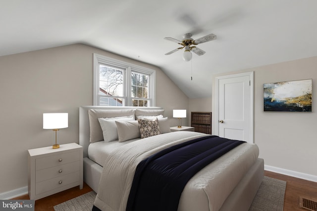 bedroom featuring ceiling fan, dark wood-type flooring, and lofted ceiling