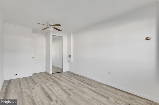 spare room featuring light hardwood / wood-style floors and ceiling fan