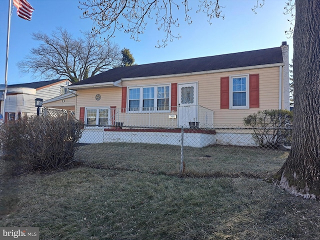 view of front of house featuring a fenced front yard and a chimney