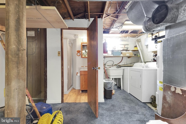 unfinished below grade area featuring washing machine and clothes dryer and carpet