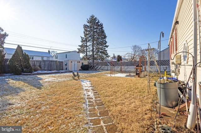 view of yard with an outbuilding and a fenced backyard