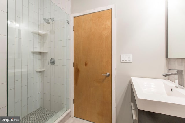 bathroom with vanity and tiled shower