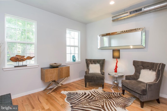 living area with hardwood / wood-style flooring