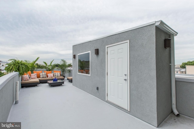 property entrance featuring a patio area and an outdoor living space