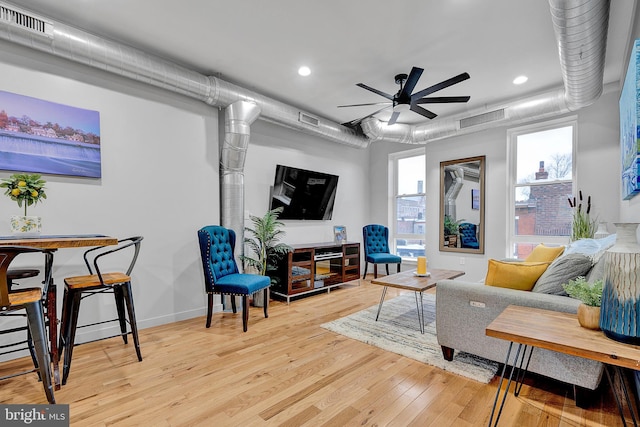 living room with light hardwood / wood-style floors and ceiling fan