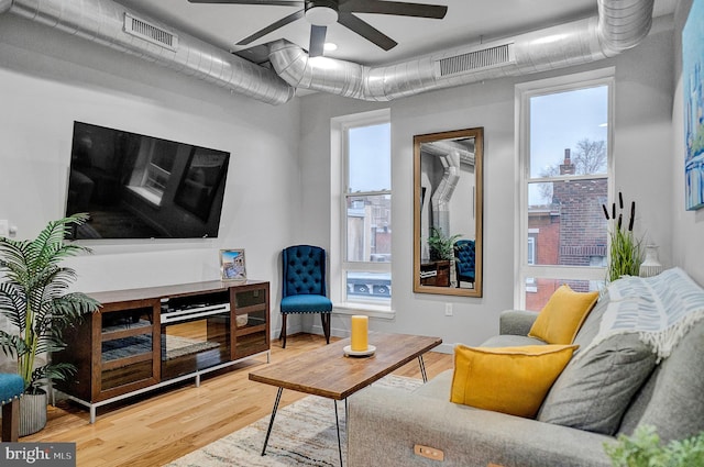 living room featuring hardwood / wood-style flooring and ceiling fan