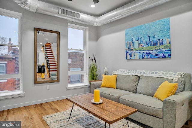 living room with hardwood / wood-style flooring and ceiling fan