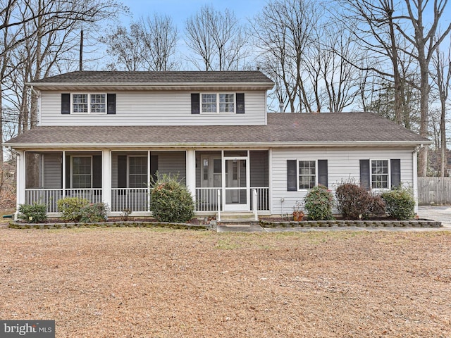 view of front of home with a sunroom and a front lawn