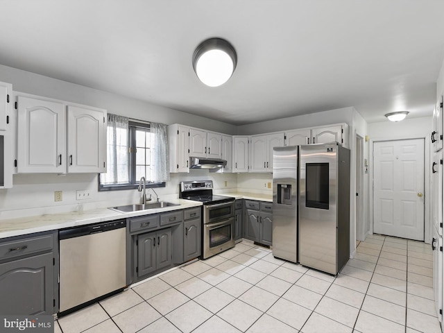 kitchen featuring sink, stainless steel appliances, gray cabinets, and light tile patterned floors