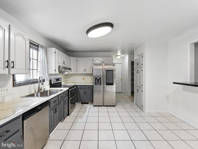 kitchen with stainless steel appliances, sink, light tile patterned floors, and gray cabinets