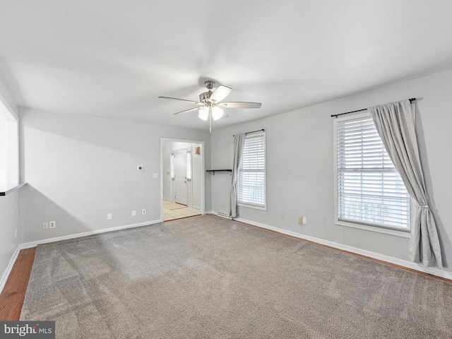 spare room featuring ceiling fan and light carpet