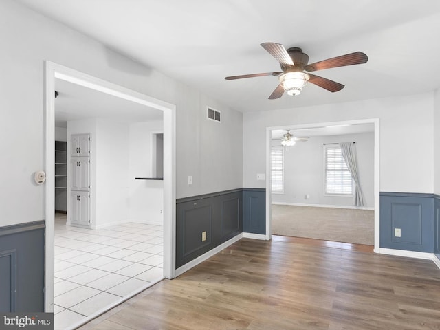 spare room with ceiling fan and light hardwood / wood-style floors