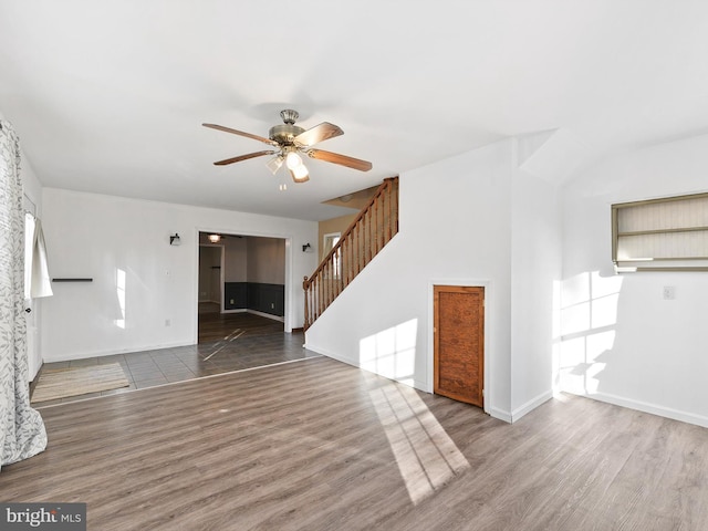 unfurnished living room featuring ceiling fan and hardwood / wood-style floors