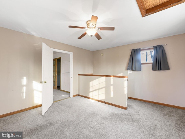 empty room featuring carpet floors and ceiling fan