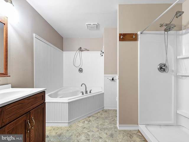 bathroom featuring shower with separate bathtub and vanity