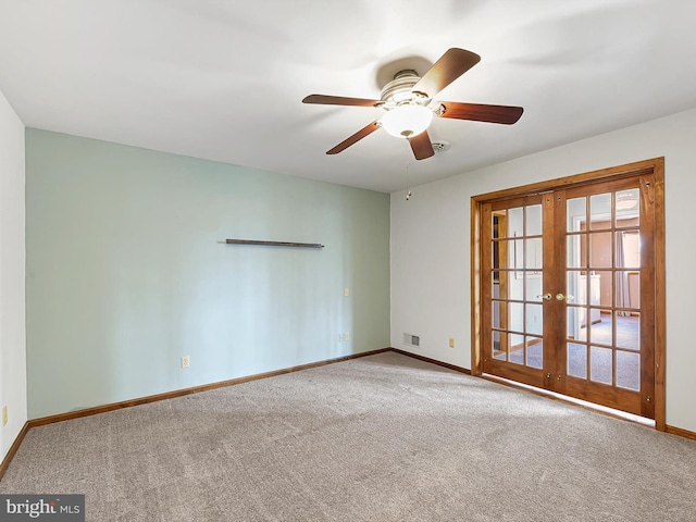 unfurnished room featuring ceiling fan, french doors, and carpet