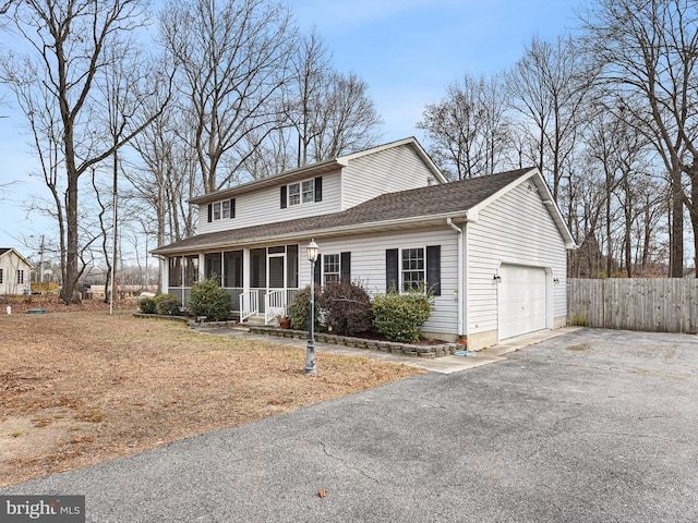 view of front property featuring covered porch and a garage