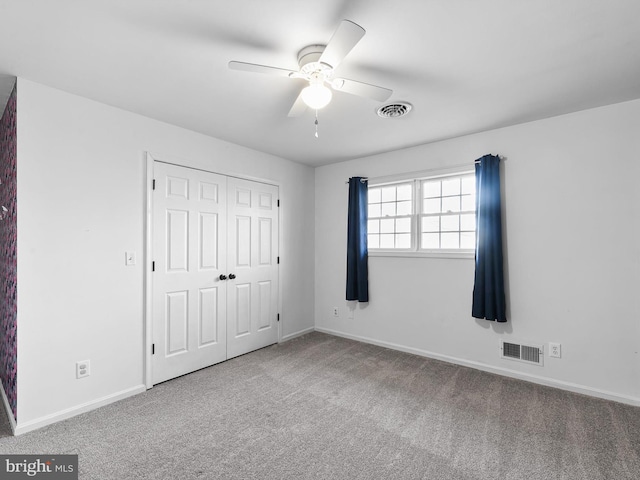 unfurnished bedroom featuring ceiling fan, a closet, and carpet floors