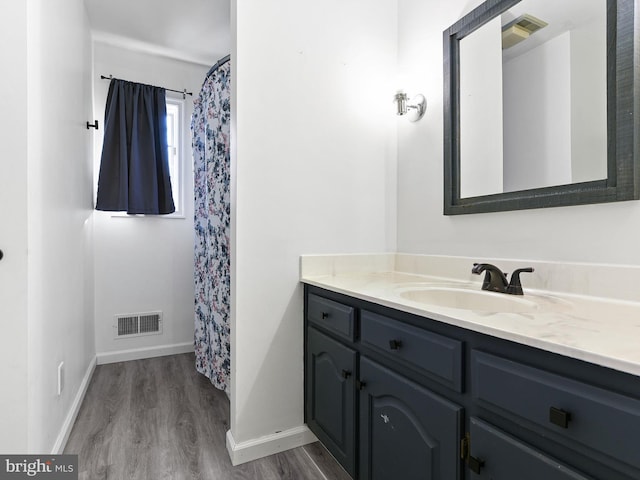 bathroom with vanity and hardwood / wood-style flooring