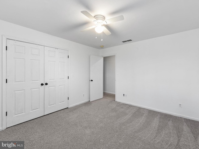 unfurnished bedroom with a closet, ceiling fan, and carpet